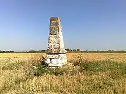 A stone milestone in a field