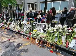 A group of citizens putting on candles at the school, following the school shooting