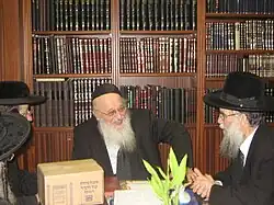 Rabbi Meir Tzvi Bergman with a packaged set of Oz Vehadar Mishna Berurahs