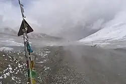 Eastbound view partly concealed by dust of passing vehicle