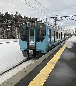 Aoimori 703 series two-car electric multiple unit (EMU) arriving at a train station
