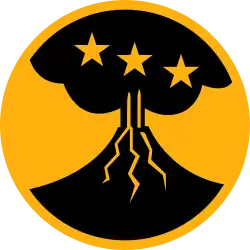 On a yellow disk 3 1/4 inches in diameter with a 1/8 inch edge, a conventionalized black volcano emitting smoke, the volcano charged with three yellow mullets in fess.