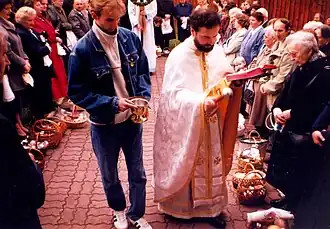 A priest blessing baskets with Easter eggs and other foods forbidden during Great Lent