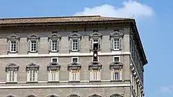 Image 18The Apostolic Palace (Palazzo Apostolico), the official residence of the pope. Here, Benedict XVI is at the window marked by a maroon banner hanging from the windowsill at centre. (from Vatican City)