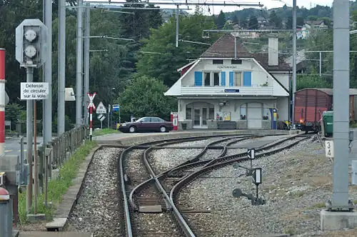 White station building next to plaform