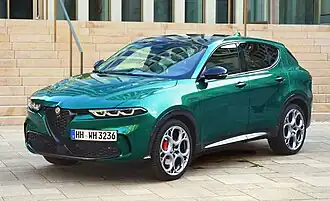 Front-three-quarter view of a five-door car with raised ground clearance, door mirrors with integrated turning indicator lights, LED headlights, and large alloy wheels