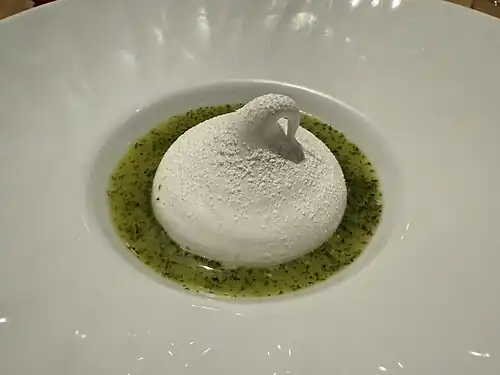 Vanilla meringue with a sweet rhubarb filling on top of a vinaigrette