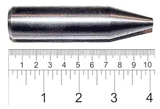 Shiny metallic cylinder with a sharpened tip. The overall length is 9 cm and diameter about 2 cm.