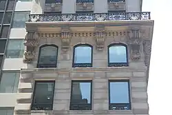 Detail of the fifth and sixth stories of the Knox Building, as seen on Fifth Avenue. The cornice above the sixth floor is carried by brackets