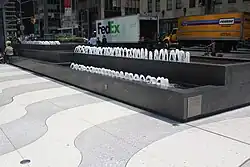 A fountain next to the sidewalk of the plaza outside 1271 Avenue of the Americas