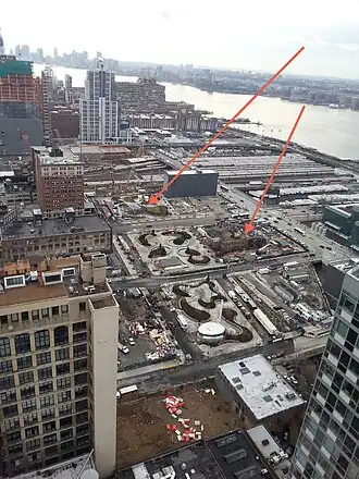 An aerial view of a construction site for the extension, with buildings surrounding it.