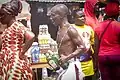 A man carrying schnapps to perform ritual during Aboakyer festival in Ghana