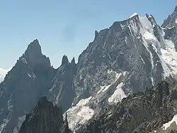 The Peuterey Ridge on the Mt. Blanc massif. From left to right Aiguille Noire de Peuterey (3773 m), Brèche-sud (3429 m), the Dames Anglaises (3601 m), Brèche-central, L'Isolée, Brèche-nord (3491 m), Aiguille Blanche de Peuterey (4112 m) and Col de Peuterey (3934 m)