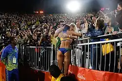 Image 17Ágatha Bednarczuk embraces the home crowd after the 2016 final. (from Beach volleyball at the Summer Olympics)