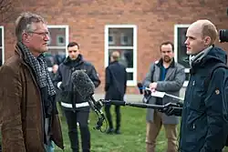 Anders Tegnell being interviewed by a reporter from a TV news station.