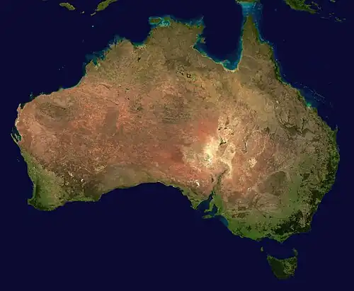 Image 15 Australia Photo: MODIS (NASA) The geography of Australia, the world's smallest continent, encompasses a wide variety of biogeographic regions. By surface area, it is the sixth-largest country in the world, but as can be seen in this composite satellite image, much of the interior is arid desert. The vast majority of the human population is concentrated along the eastern and southeastern coasts, and it is the fiftieth most populous nation. More selected pictures