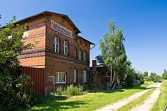 The old station building in Wustrow. The tracks end behind the blue containers by the silo.