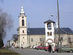 Street in Bajmok, the Catholic Church (right), and bell-tower of the Orthodox church (left)