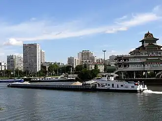 Alfortville and Chinagora, with a barge and tugboat on the River Seine