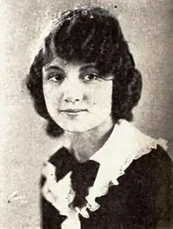A young woman with short dark wavy hair