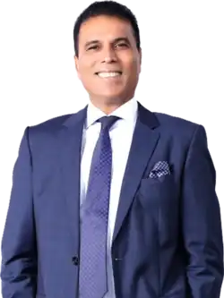 Colour photo headshot of Bikram Pandey wearing a blue suit with a white shirt and blue tie