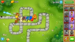 An in-game screenshot of several different monkeys attacking the Bloons and supporting each other.