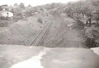 A black and white image of a single line going through a cutting