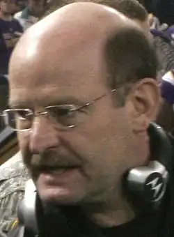 Head shot of bald white man (Brad Childress) with headset