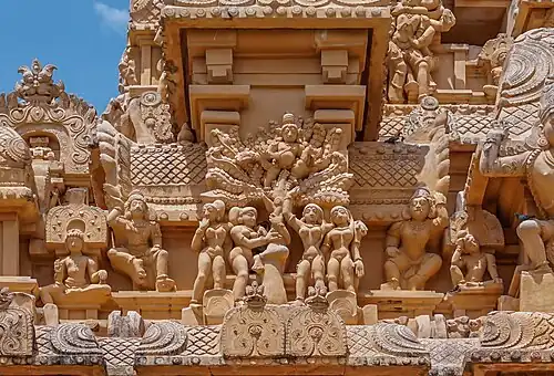 Krishna playing prank on gopikas by hiding on the tree, with their clothes