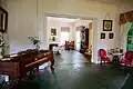 Photograph of the interior of the Bronson–Mulholland House standing in the front parlor and looking into the rear parlor.