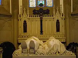 Tomb with effigies of Emperor Pedro II of Brazil and his wife Teresa Cristina in front of an altar crucifix in the Cathedral of Petrópolis, Brazil. The cross is made of black granite from Tijuca forest.[40]