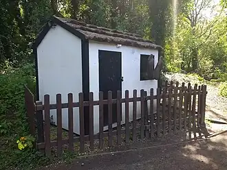Depiction of Middleton's house at Speke Hall. His feet are hanging through the window and when approached snoring is heard.