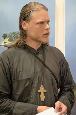 Chris O'Moore holding the opening of an art exhibition in Mytilene in 2016