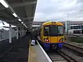 An overground train terminates at Clapham Junction