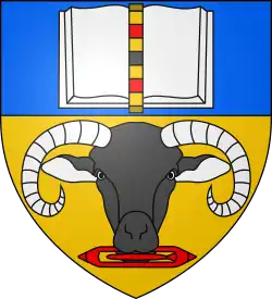 A heraldict design featuring book above a curve-horned ram holding a weaving shuttle in its mouth.