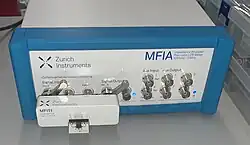 Computer controlled impedance analyzer based on the direct I-V mode with test fixture attached.