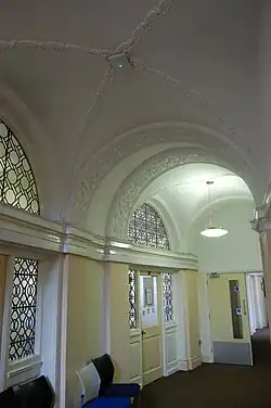 The interior corridors have decorative plasterwork and leaded windows