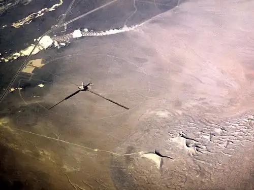2012 January – The solar tower under construction as seen from a commercial airliner. The eponymous Crescent Dunes are at lower right.