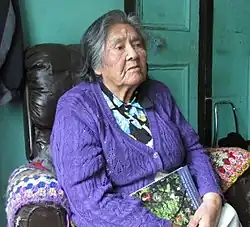 A photo of Cristina Calderón in 2013, sitting in a chair