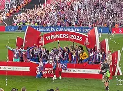 Players from Crystal Palace celebrating in front of their fans with the FA Cup