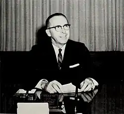 Dean Colvard sitting at a desk wearing business attire