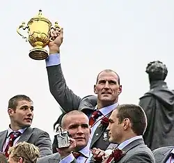 Lawrence Dallaglio holding the Rugby World Cup.
