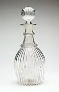 A glass decanter and stopper
