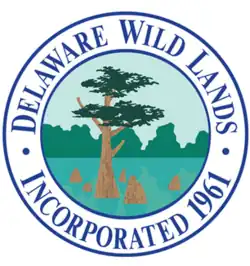 Drawing of a tree in a like within a circle with the following written around the edge: "Delaware Wild Lands Incorporated 1961"