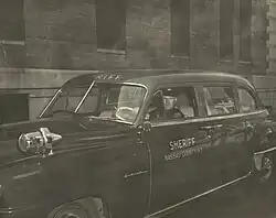 Deputy sheriff outside the Mineola courthouse, circa 1955