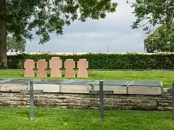 Plaques with the names of identified soldiers killed in action in the community graves (in front of the stone crosses)