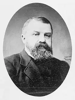 Formal portrait photograph of Dwight Lyman Moody, a middle-aged man with a beard wearing a dark suit