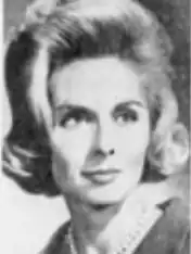 A blonde white woman with hair in a bouffant set.
