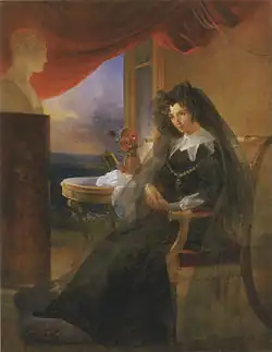 Elizabeth Alexeevna in mourning, seated next to a photo of her late husband