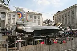 A fighter jet parked in the street
